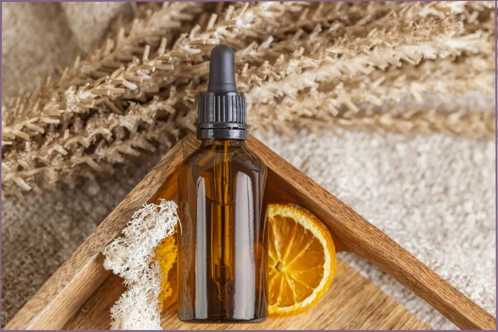 Thanksgiving essential oil blend on a wooden box next to a lemon slice