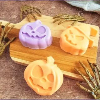 Jack O lantern shaped Halloween melt and pour soaps in orange and purple