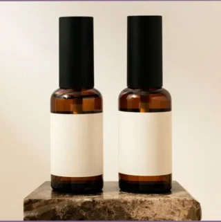 two small dark-glass spray bottles for DIY fall room sprays with essential oils