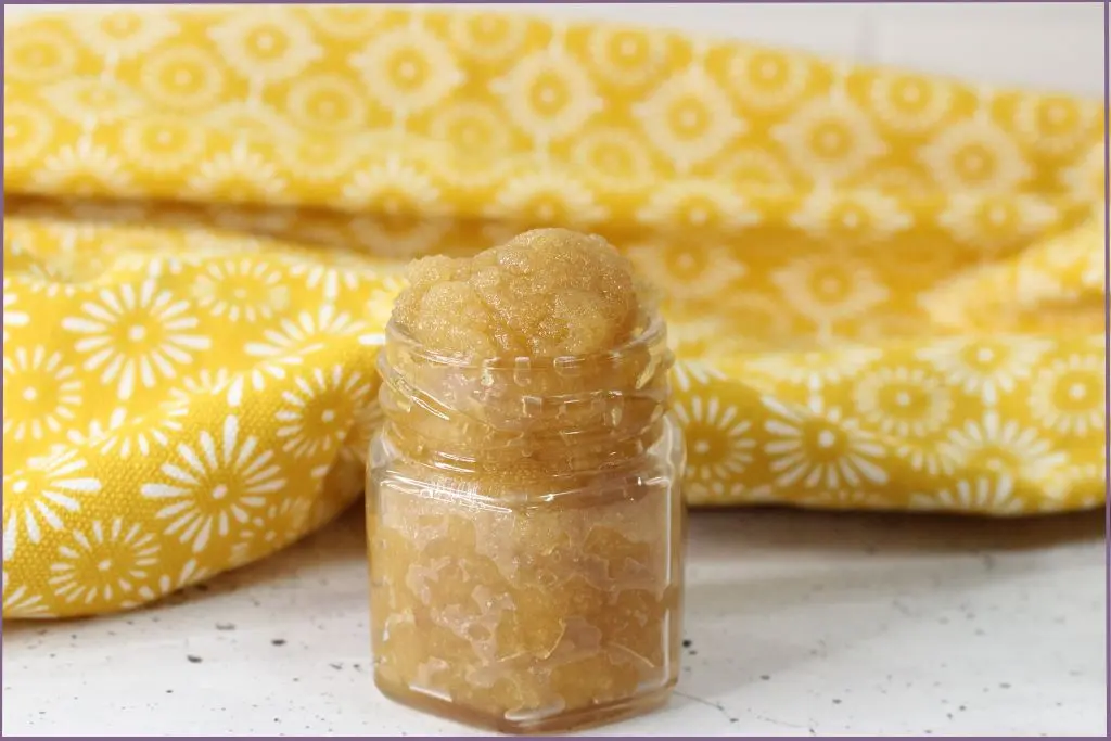 Homemade honey lip scrub stored in a small glass jar + shelf life