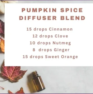 fall leaves, white pumpkin and an essential oil bottle