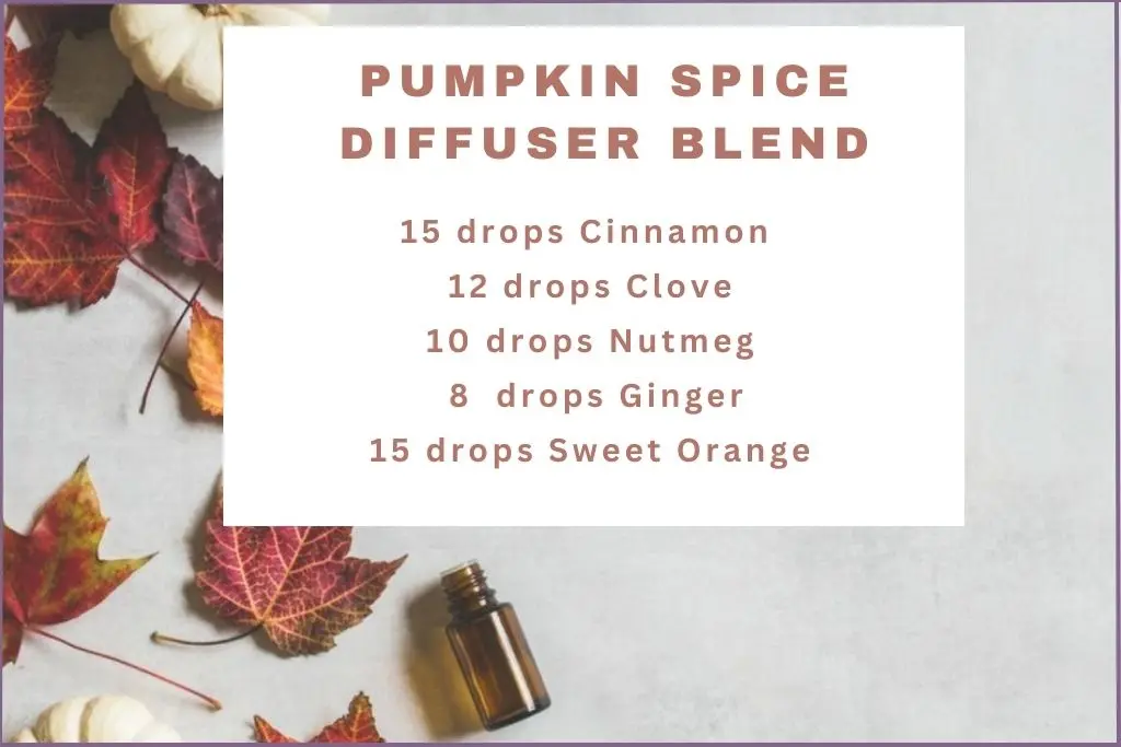 fall leaves, white pumpkin and an essential oil bottle