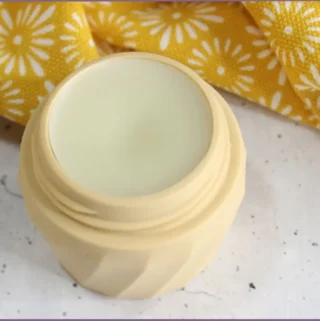 small balm container filled with DIY cuticle balm with shea butter