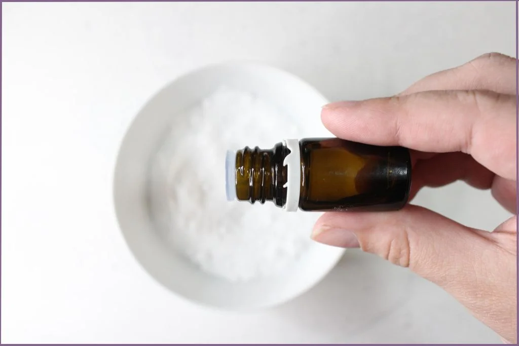 Lady adding essential oil to shower steamer ingredients