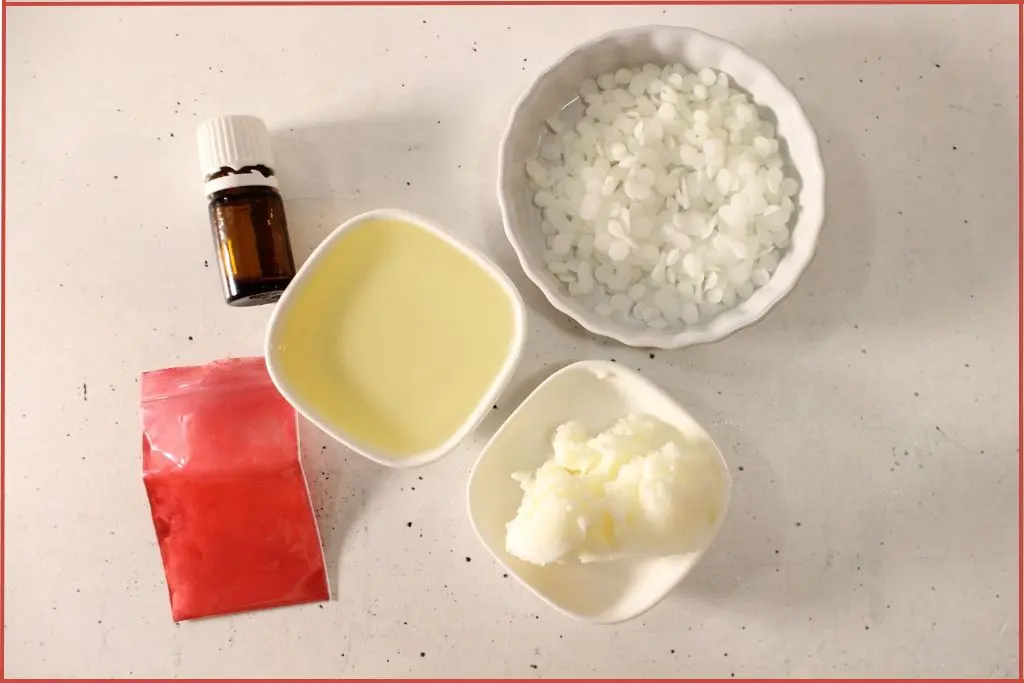 Ingredients to make candy cane lip balm - beeswax, coconut oil, jojoba oil, and red mica powder