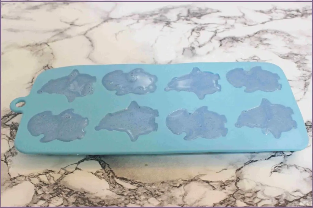 Penguin soap mold with melted soap left on the table top to set