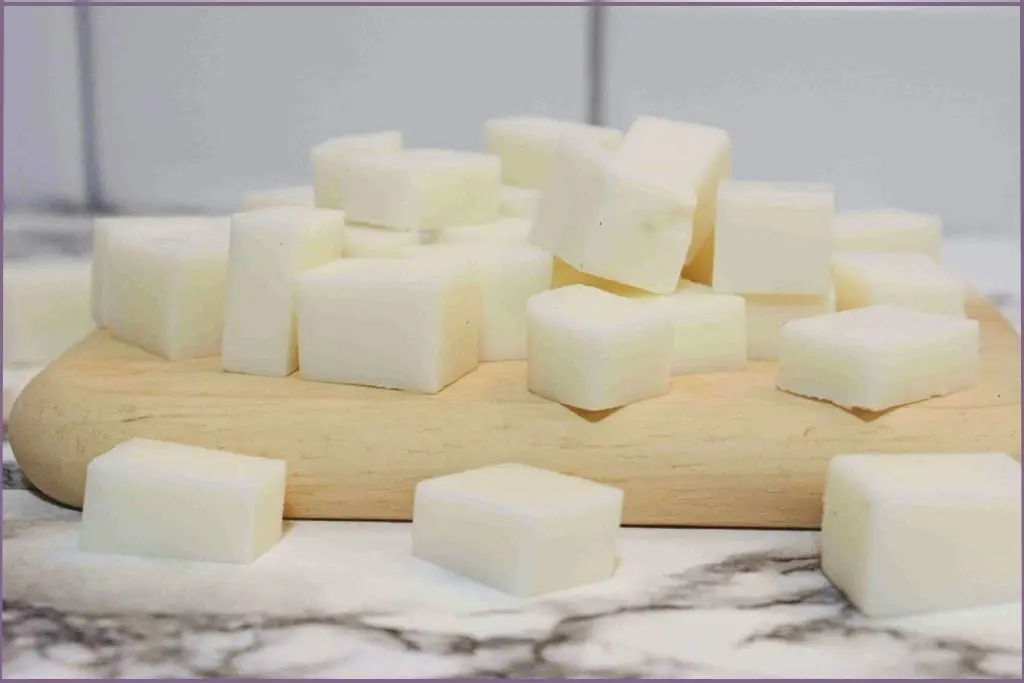 Melt and pour soap base cut into small cubes on a wooden cutting board