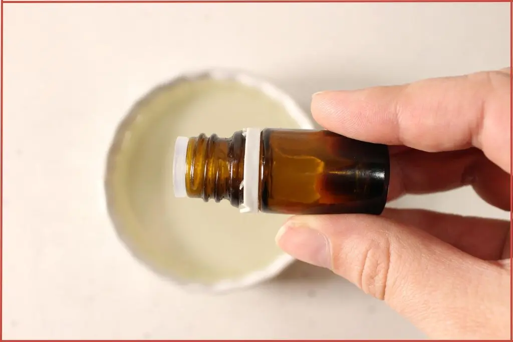 Adding essential oil to coconut oil to make gingerbread sugar scrub