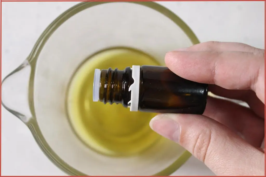 Adding essential oil to carrier oil for diluting before using in homemade skincare DIY