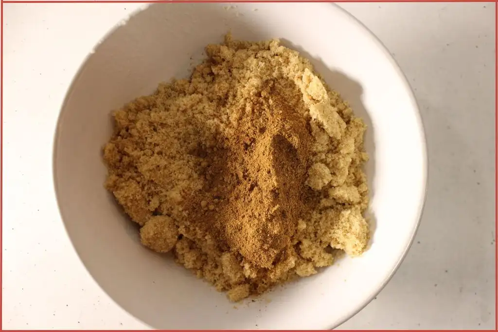 Mixed spices and brown sugar in a bowl to be mixed for making gingerbread sugar scrub