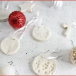 White salt dough Christmas diffuser ornaments in festive shapes with ribbon and red and white baubles - instructions on how to make