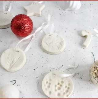 White salt dough Christmas diffuser ornaments in festive shapes with ribbon and red and white baubles - instructions on how to make