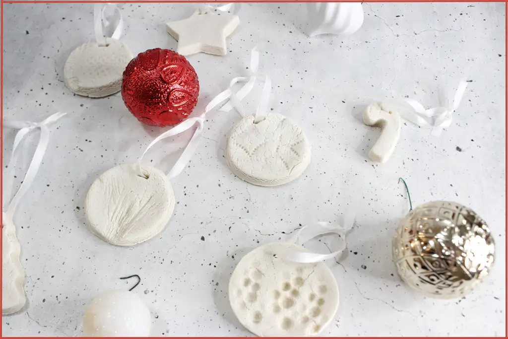 White salt dough Christmas diffuser ornaments in festive shapes with ribbon and red and white baubles - instructions on how to make