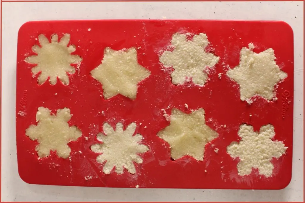 Red mold packed with 8 snowflake sugar bars mix kept aside to set