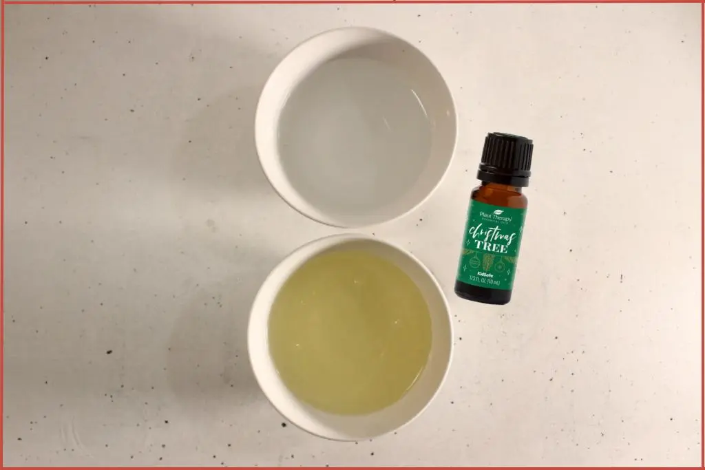 2 bowls with Castile soap and distilled water and a bottle of Plant Therapy Christmas tree blend to make foaming hand soap