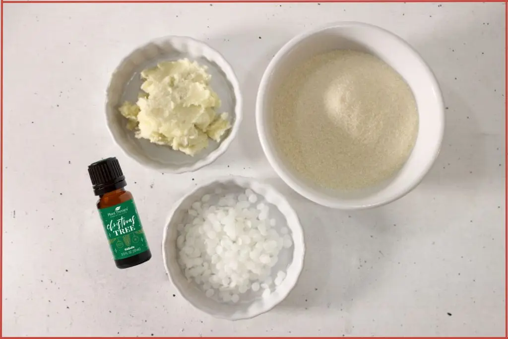 Bowls of shea butter, beeswax and sugar + bottle of Plant Therapy essential oil - ingredients to make snowflake sugar scrub bars