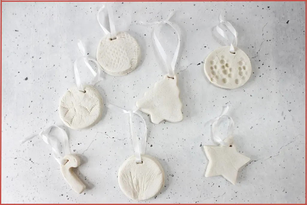 Homemade diffuser ornaments in assorted Christmas shapes kept on a flat surface to dry