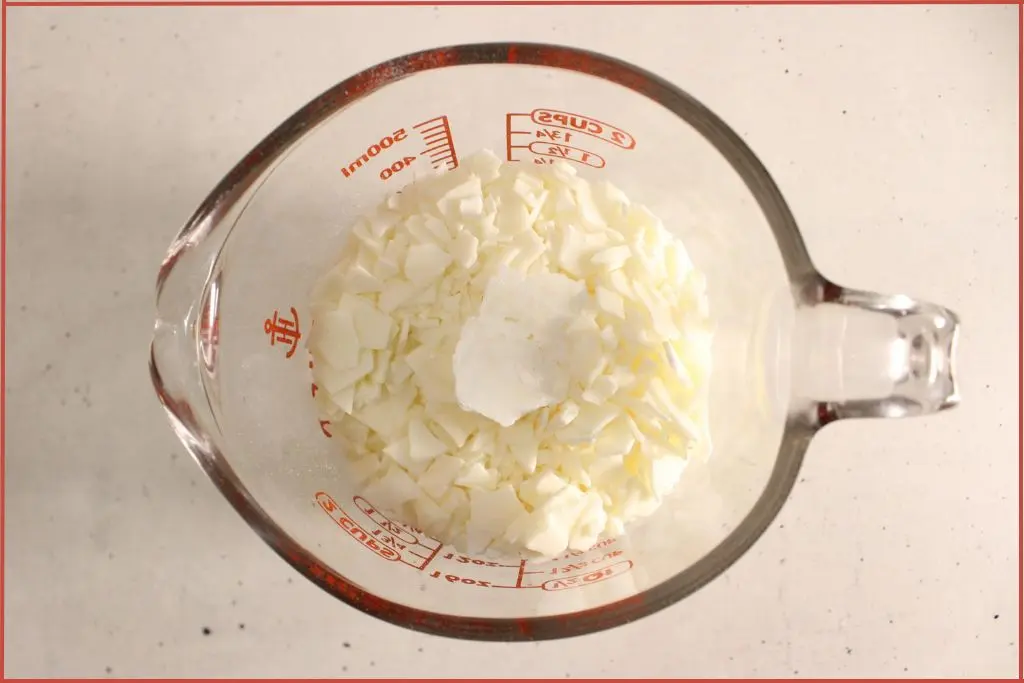Soy wax flakes in a glass jar to be melted