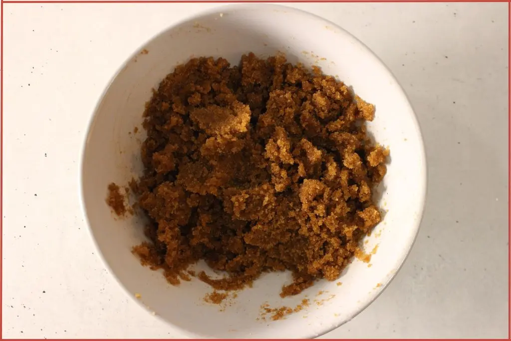 White bowl with sugar, spices and oils mixed together to make gingerbread sugar scrub