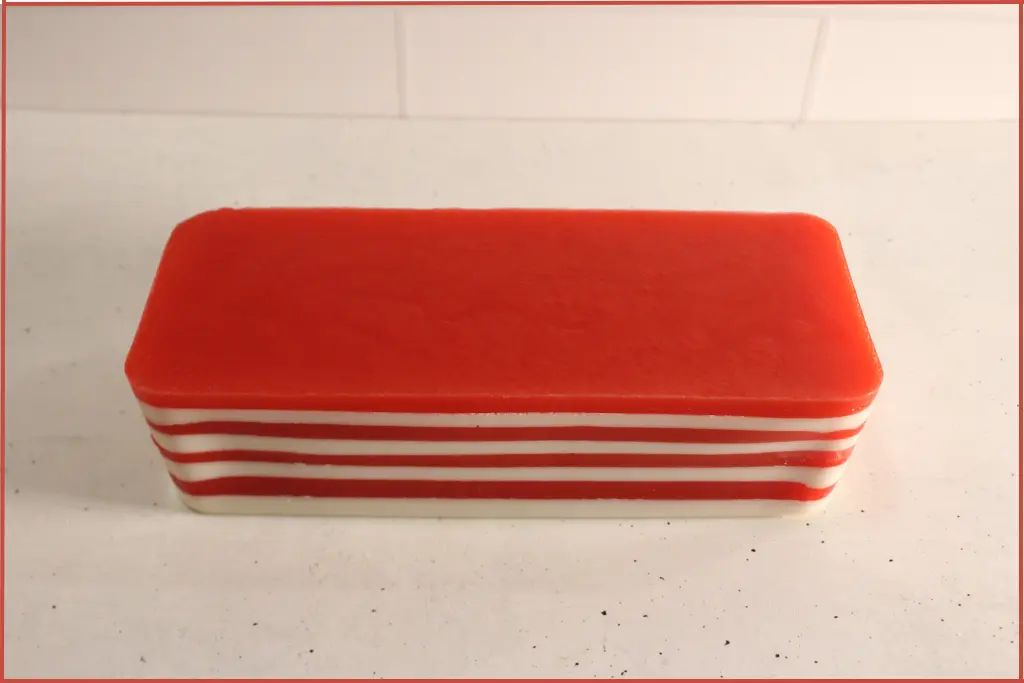 Top view of homemade candy cane melt and pour soap showing distinct red and white layers