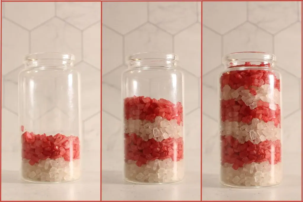 Step-by-step view of a clear jar being filled with alternating red and white layers of candy cane bath salts, showing the jar one-third, two-thirds, and fully filled.