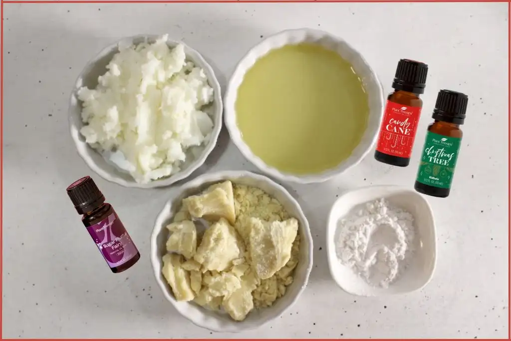 Ingredients to make whipped Christmas hand cream with essential oils - cocoa butter, tallow, arrowroot powder, carrier oil, and essential oils