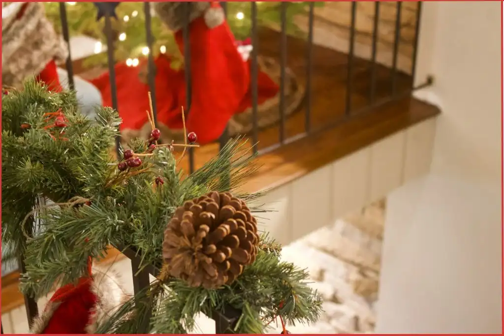 Fresh fir garland with pinecones wrapped around a staircase railing
