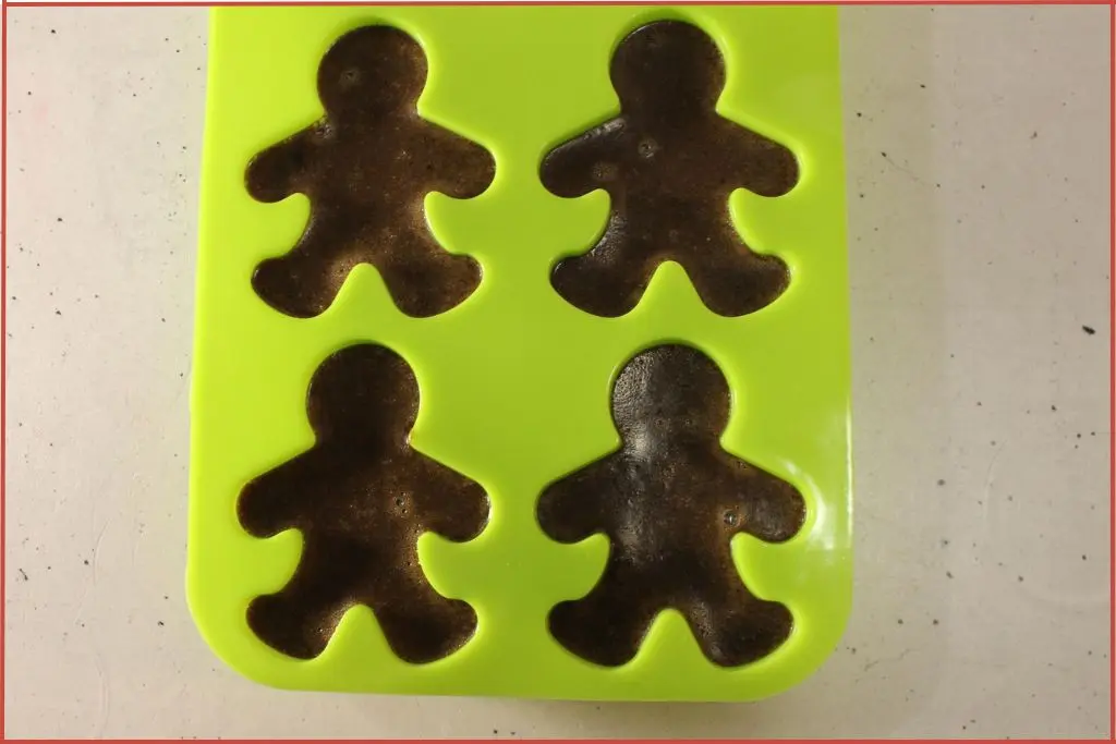 Melted soap setting in gingerbread soap mold
