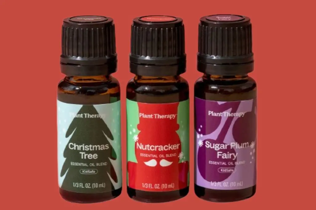 Bottles of Plant Therapy Christmas tree, nutcracker, and sugar plum fairy essential oil blends used to scent DIY projects